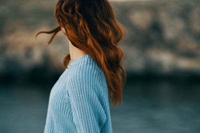 Rear view of woman standing in water