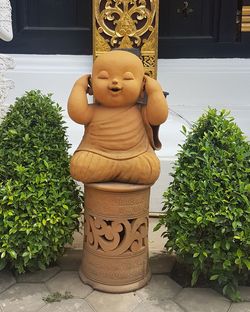 Close-up of buddha statue on potted plant