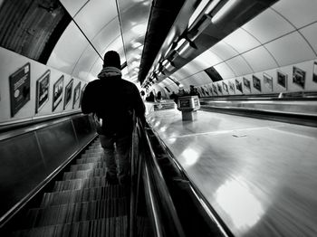 Rear view of man walking in corridor