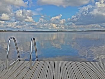 Pier on lake against sky