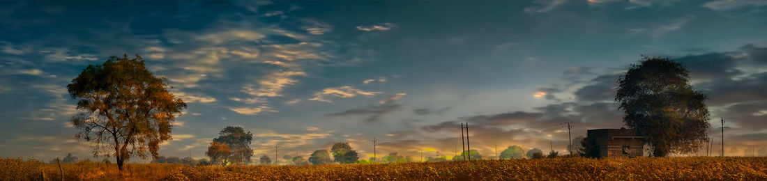 Panoramic view of field against sky during sunset