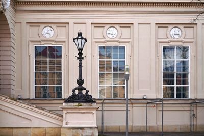 Low angle view of street light against building