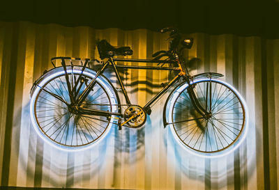 Close-up of bicycle parked against wall