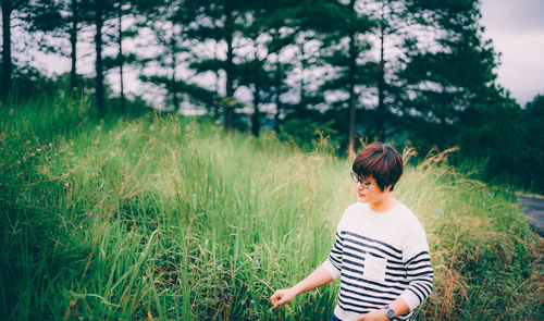 Rear view of woman standing on field