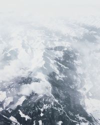 Aerial view of snowcapped mountains against sky