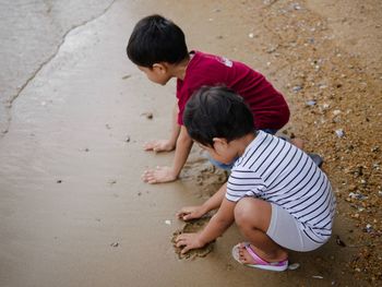 High angle view of father and son on sand