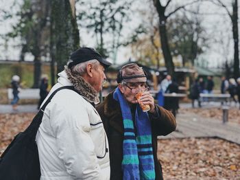 People standing by tree during winter