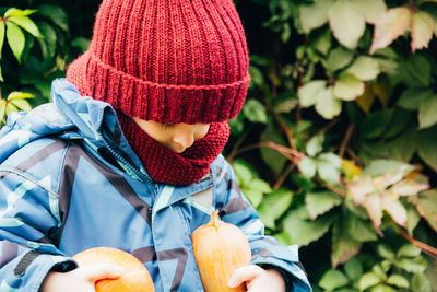 Autumn, little child holding an orange pumpkin. thanksgiving and halloween season. 