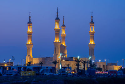 Illuminated buildings against sky at night