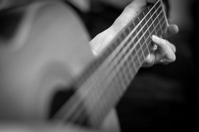 Close-up of woman playing guitar