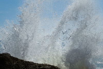 Full frame shot of waves splashing on cliff