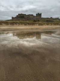 Scenic view of landscape against cloudy sky