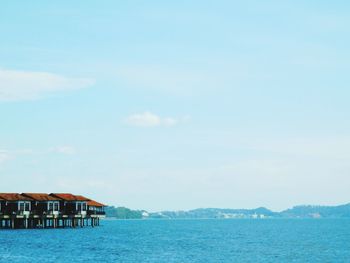 Scenic view of sea and buildings against sky