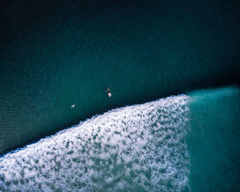 High angle view of sea against clear blue sky