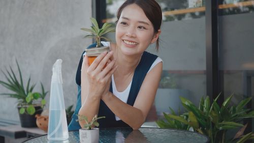 Young woman sitting on table at restaurant