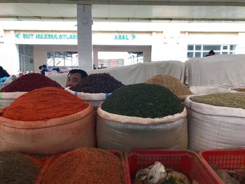 People sitting at market stall