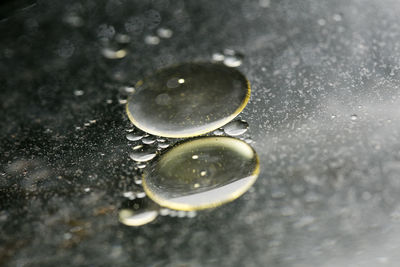 High angle view of raindrops on wet table