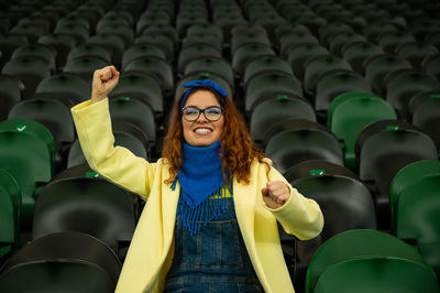 Portrait of woman standing in stadium