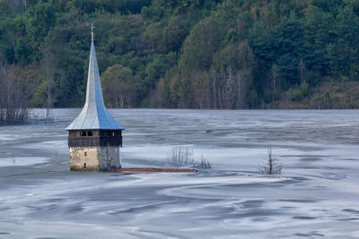 Built structure on snow covered land in forest