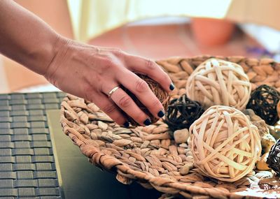 Cropped image of woman keeping object on table