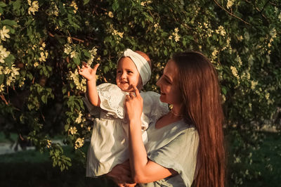 Side view of young woman using mobile phone