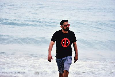 Young man wearing sunglasses on beach