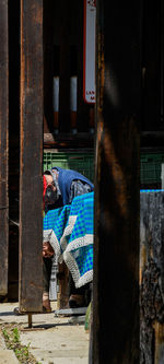 Rear view of woman standing by built structure