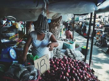 People working at market stall