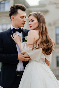 Bridegroom standing outdoors