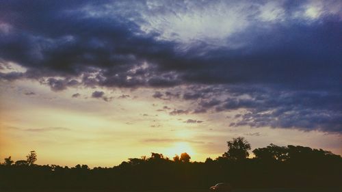 Silhouette trees against sky during sunset