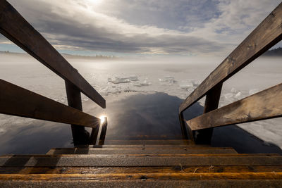 Bridge over empty road against sky