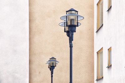 Lamp posts against wall