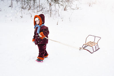 Low angle view of woman standing on snow