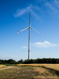 Windmill on field against sky