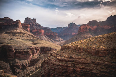 Scenic view of mountains against cloudy sky