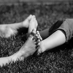 Low section of woman lying on grass