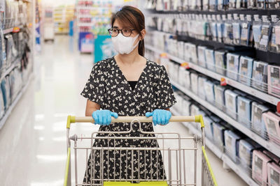 Woman looking away while standing at store