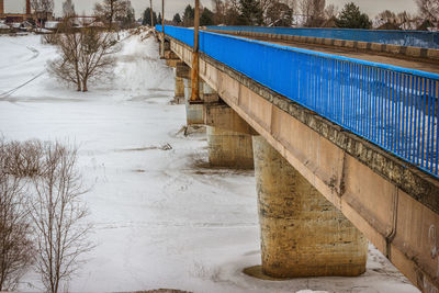 Bridge over river during winter