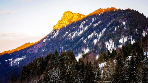 Low angle view of snowcapped mountain against sky during sunset