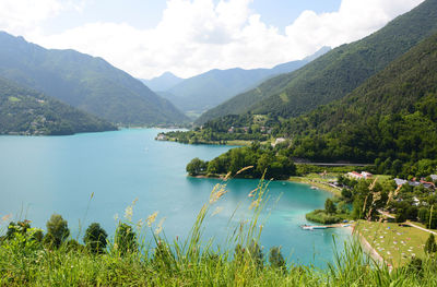 Scenic view of lake and mountains against sky