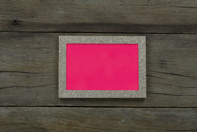 Directly above shot of pink art on table against wall