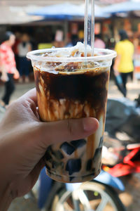 Close-up of hand holding coffee cup