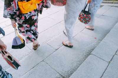 Low section of people walking on staircase