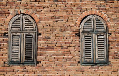 Old woden windows on brick wall