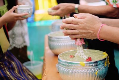 Cropped hands of person doing religious offering