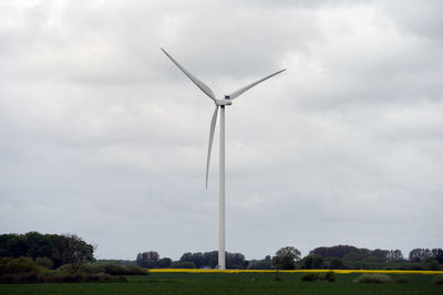 Low angle view of windmill against sky