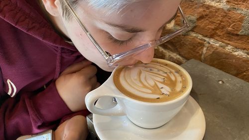 Midsection of woman with coffee cup