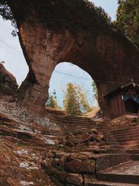 Low angle view of rock formation against sky