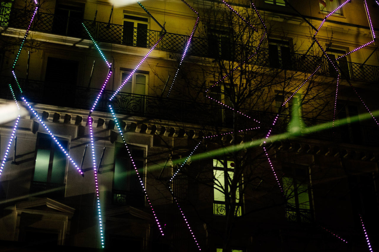 LOW ANGLE VIEW OF ILLUMINATED LIGHTS ON CEILING AT NIGHT