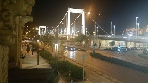 View of bridge over city at night